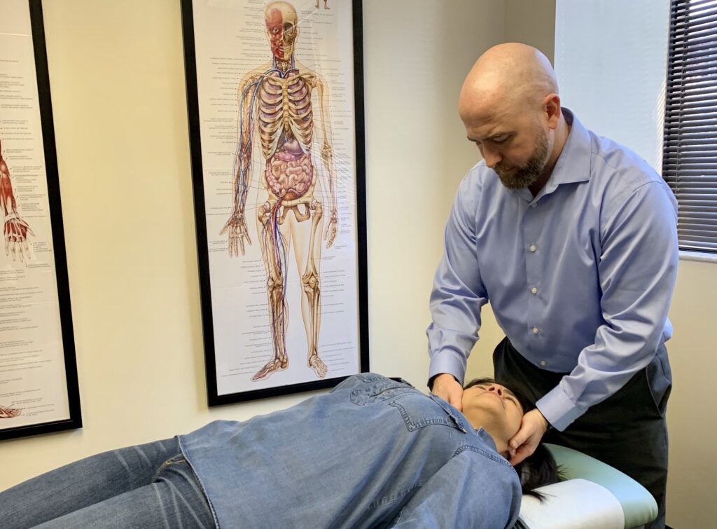 Dr. Michael White, Chiropractic Physician performing an adjustment for a disc herniation.